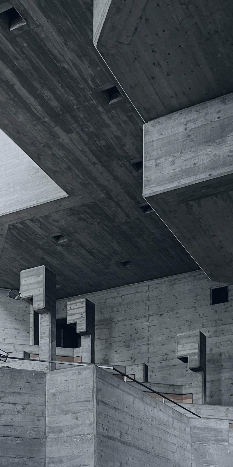 Massive concrete architectural structure with layered support beams and reinforced geometric forms representing stability, protection, and long-term asset preservation.