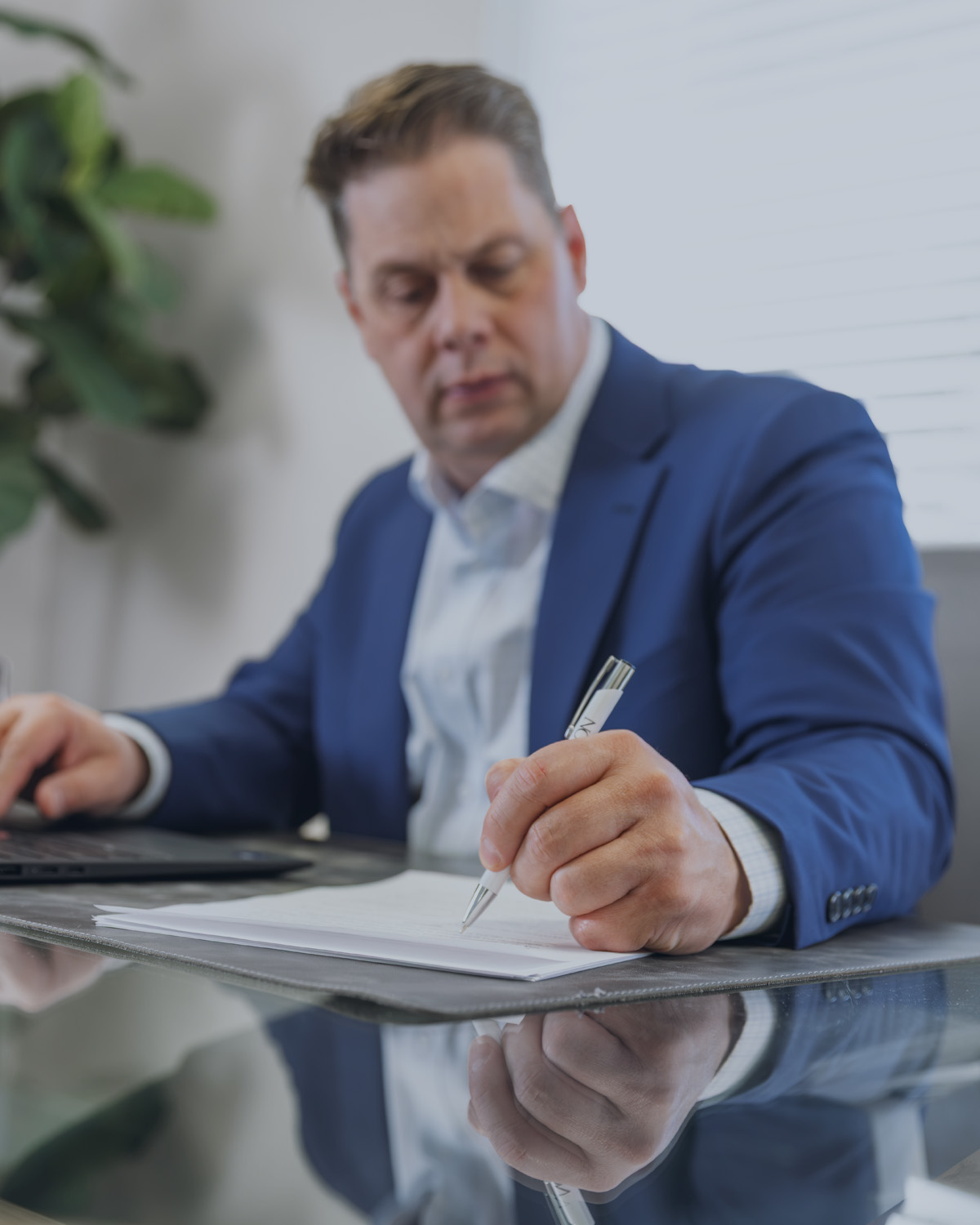 Jeff Cardon reviewing estate planning documents at his office in Pleasant Grove, Utah.