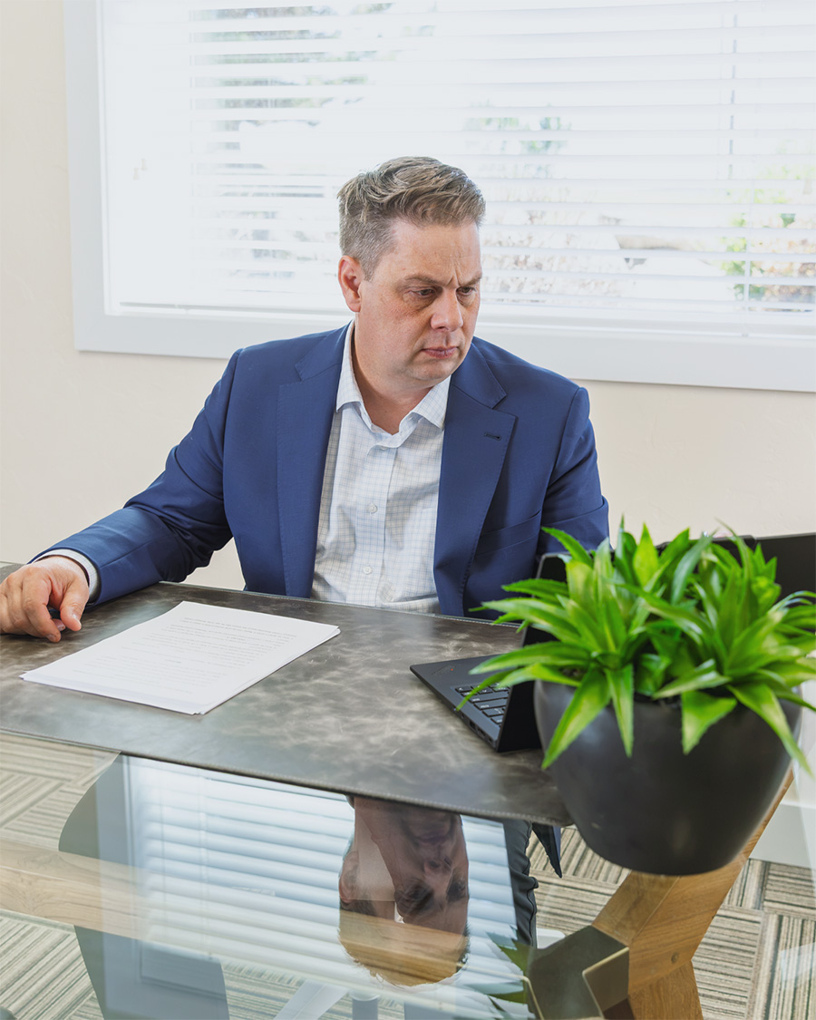 Jeff Cardon reviewing estate planning documents at his office