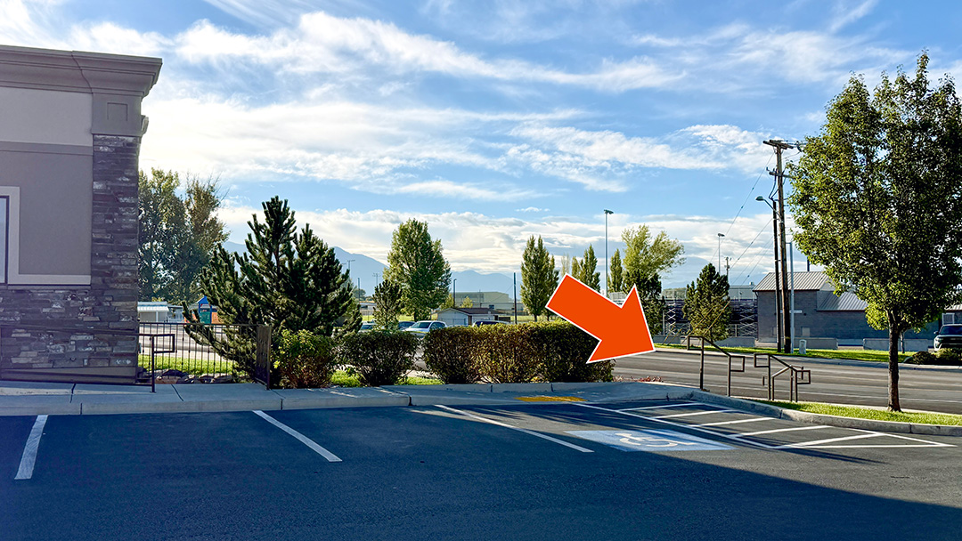 Cardon Law office building viewed from the parking lot, with an orange arrow pointing to the stairs on the right side.