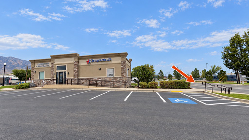 Cardon Law office building viewed from the parking lot, with an orange arrow pointing to the stairs on the right side.