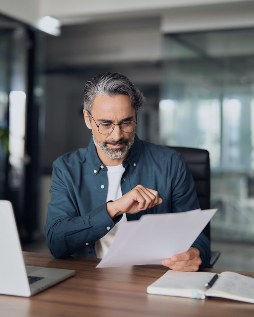 Founder reviewing business ownership and estate planning documents in an office